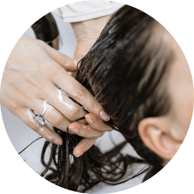 a women washing hair with soap | Dimethicone Supplier