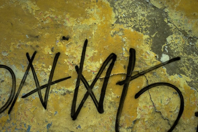 Abstract black graffiti on an old grunge wall